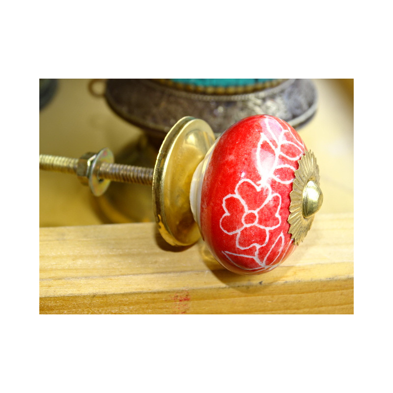Red porcelain drawer handle and white flowers