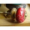 Red porcelain drawer handle and white flowers