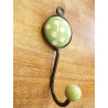 coat with one hanger a light green round  with white dots
