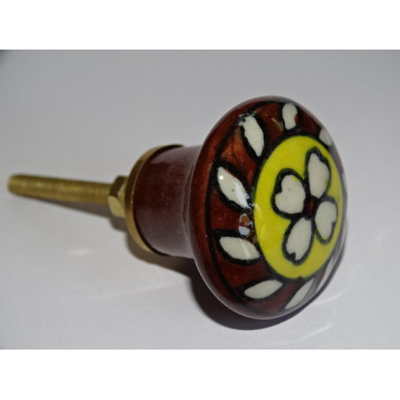 brown and yellow porcelain button with white flower